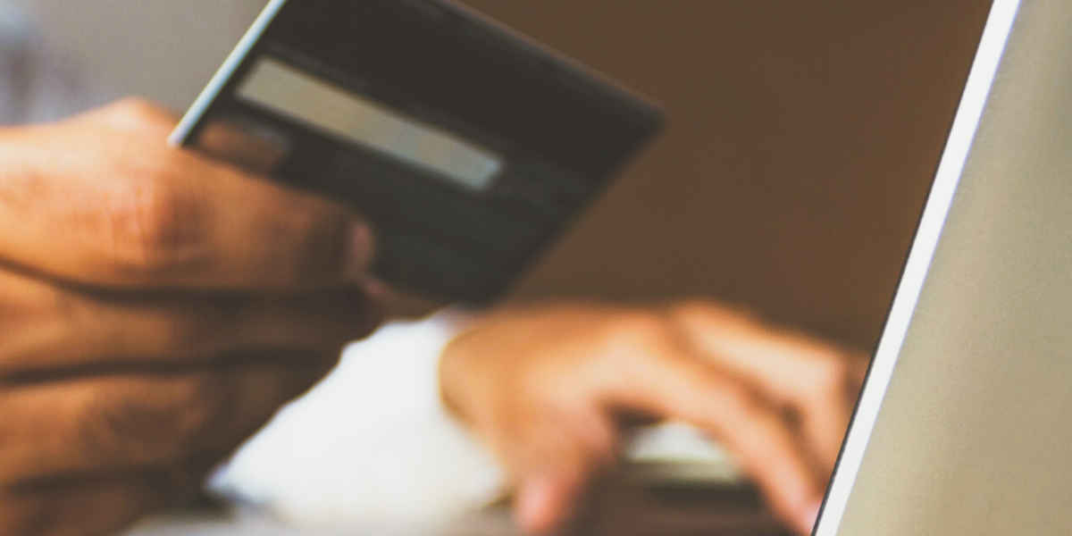 man buying with credit card on computer